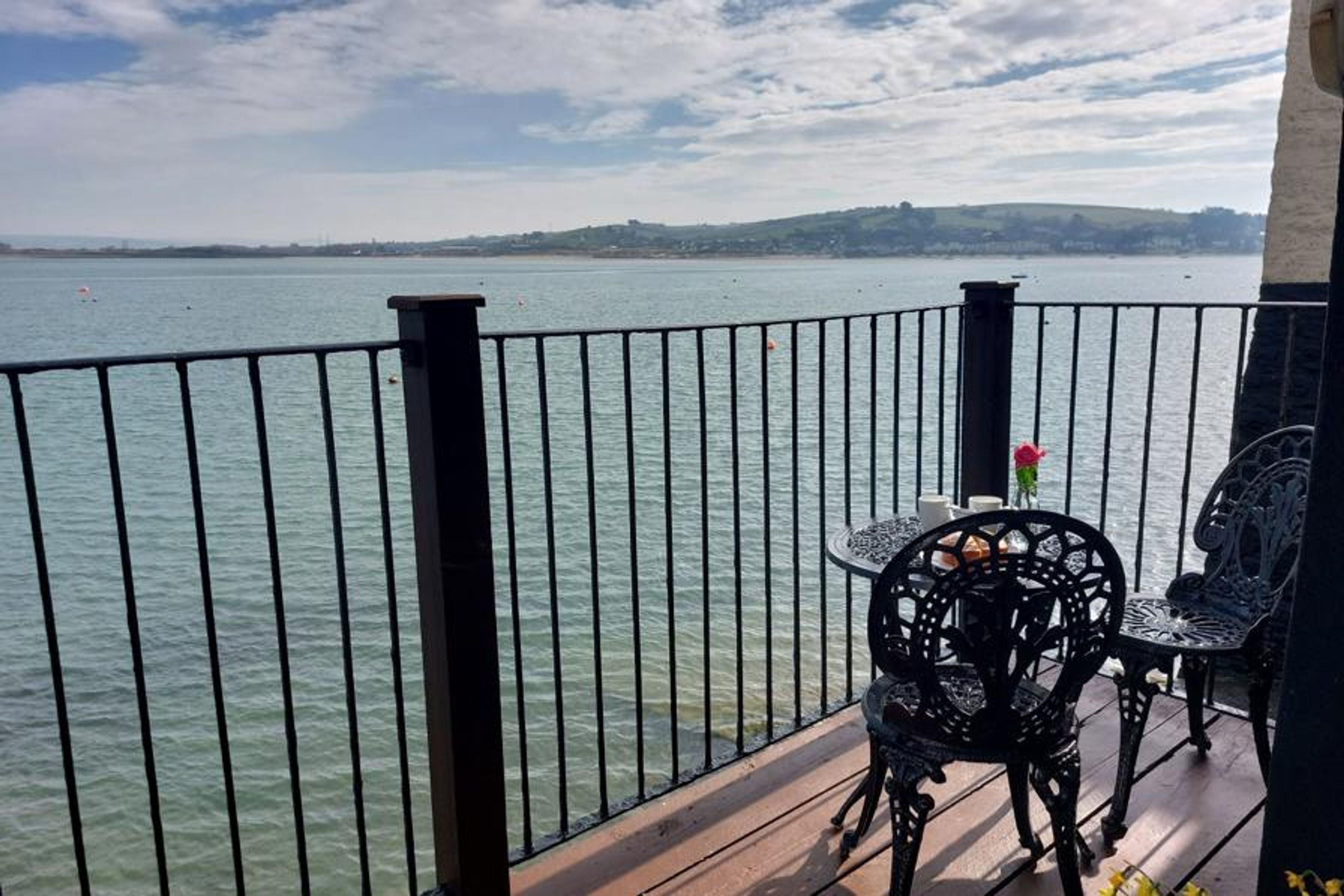 Shoreline Balcony And Seating Area With Coastal View