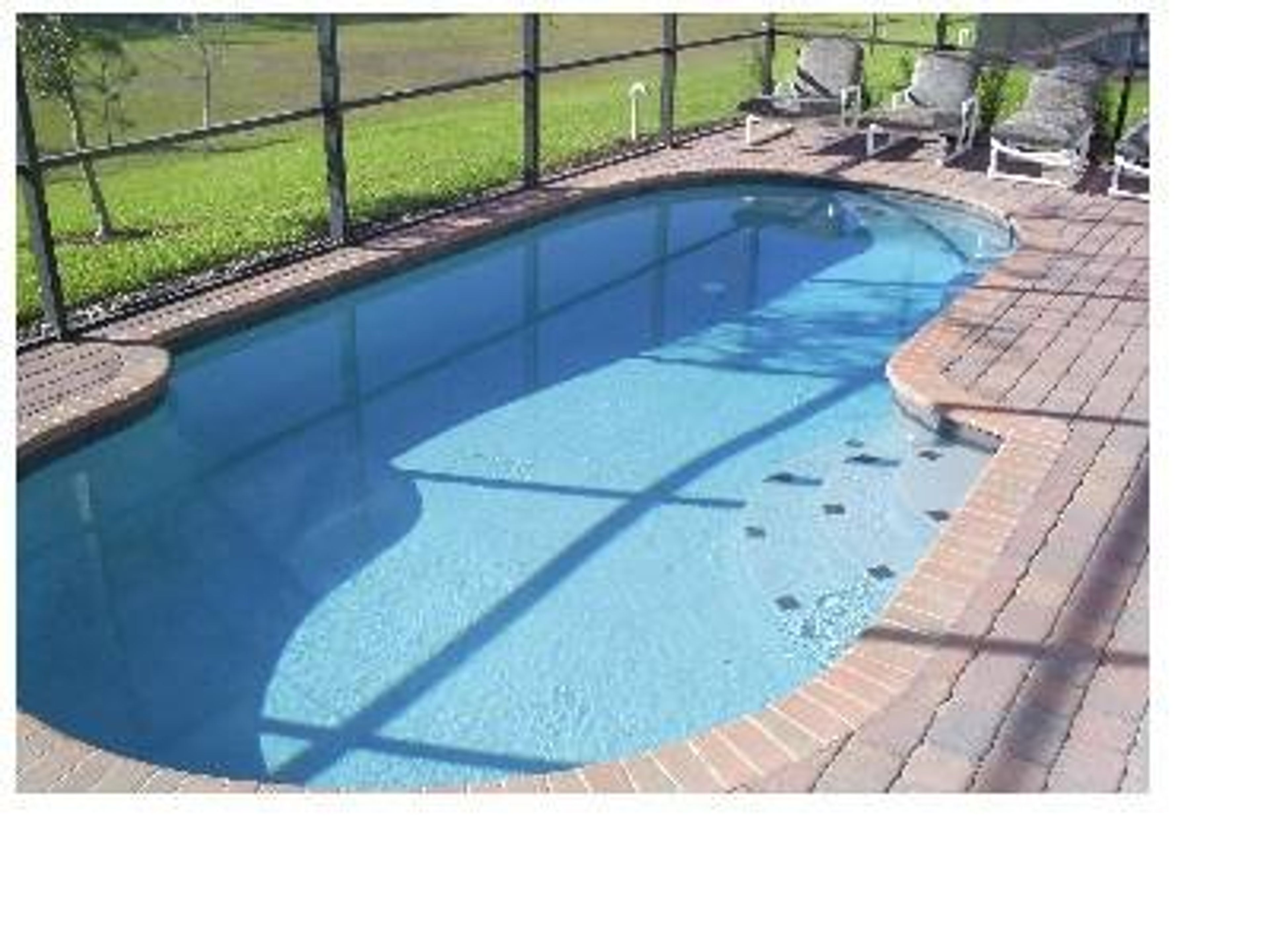 14 by 28 foot pool, surrounded by a patio area with sun loungers