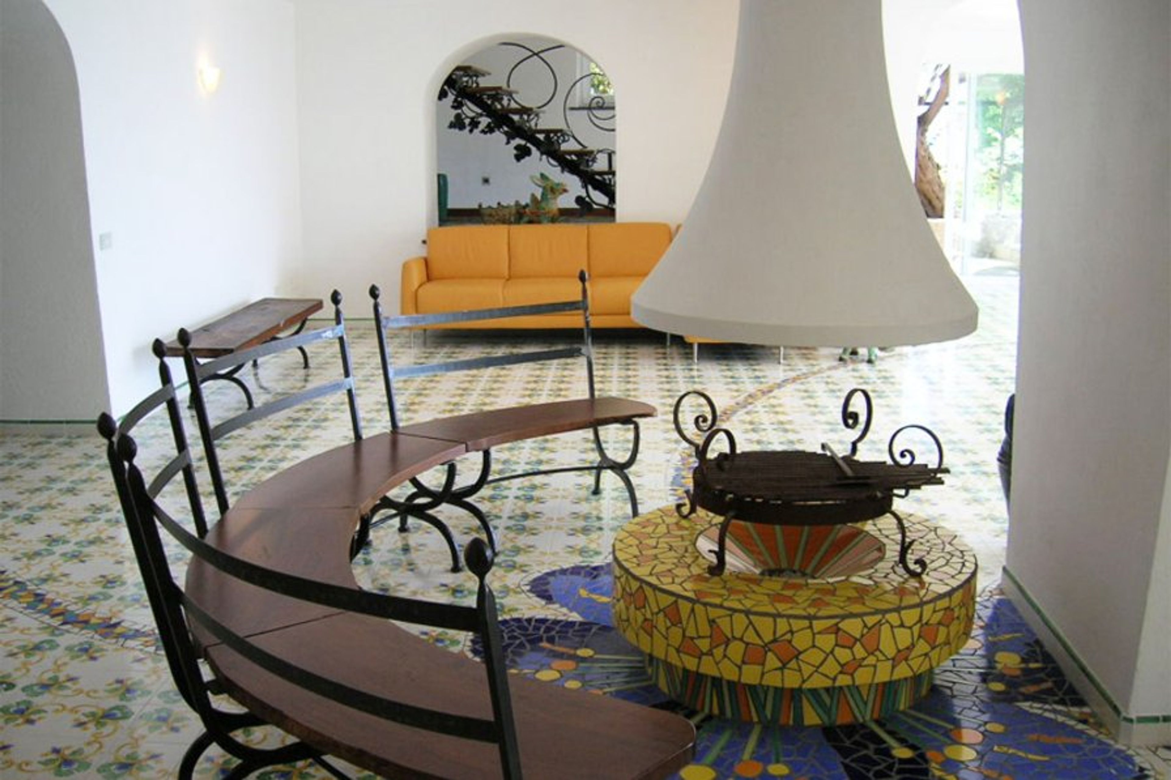 Living area with fireplace and double sofa bed at villa sorrento coast