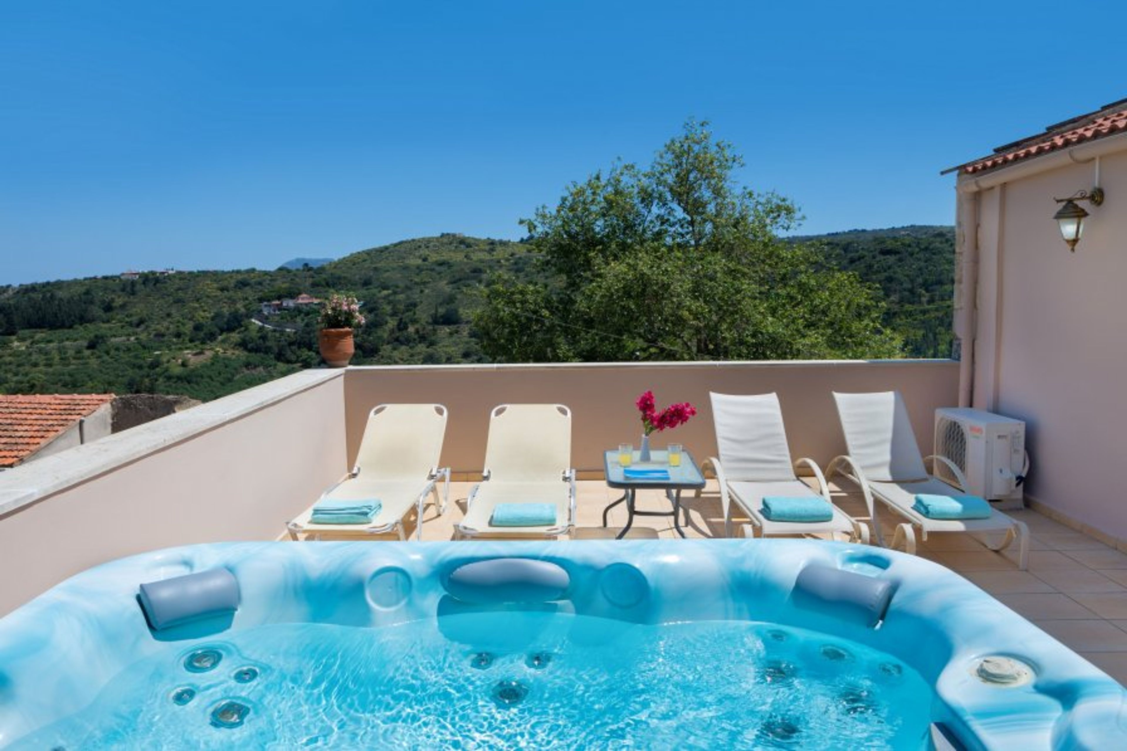 private heated jacuzzi on the terrace with sunbeds,umbrella and table