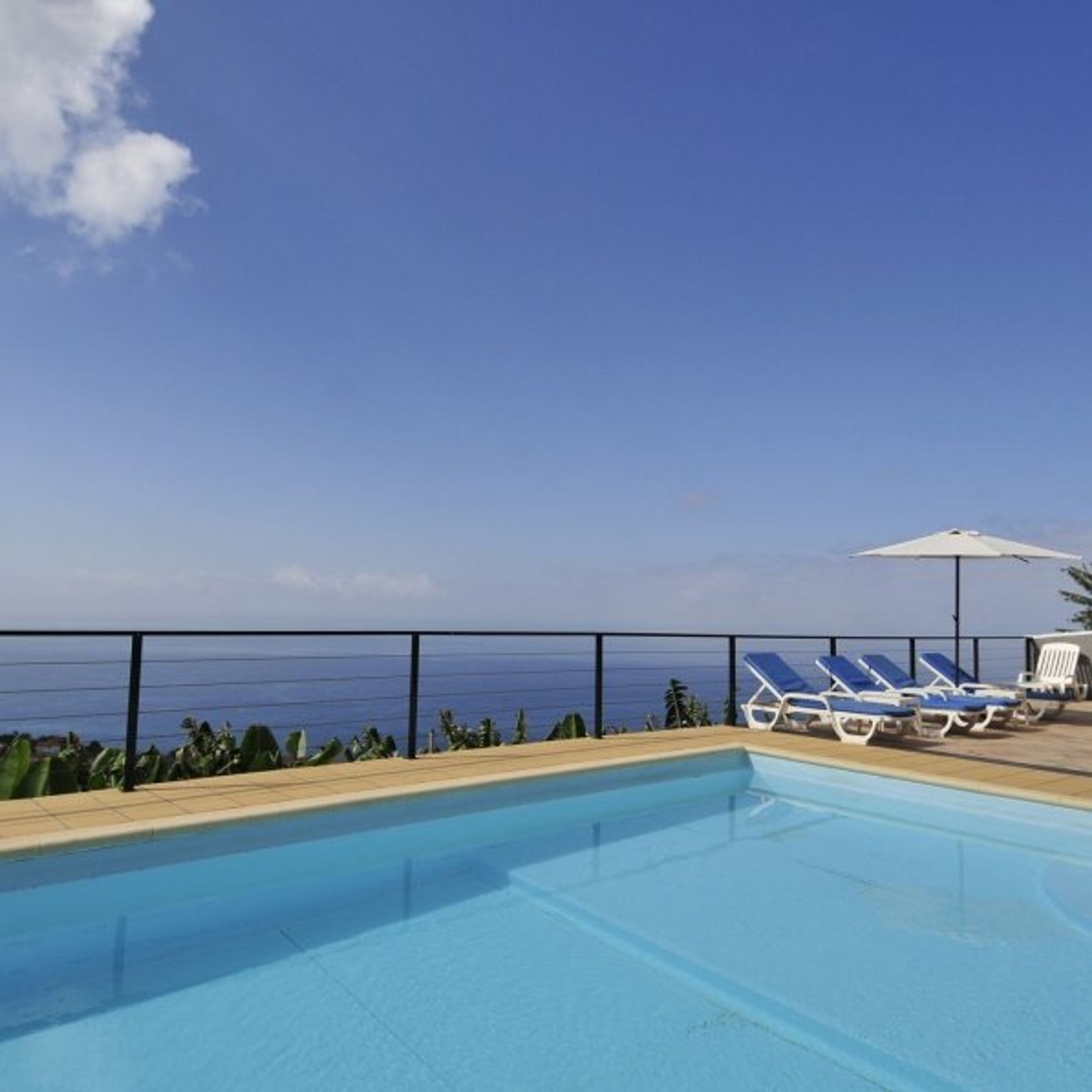 Private swimming pool with sunbathing patio. 