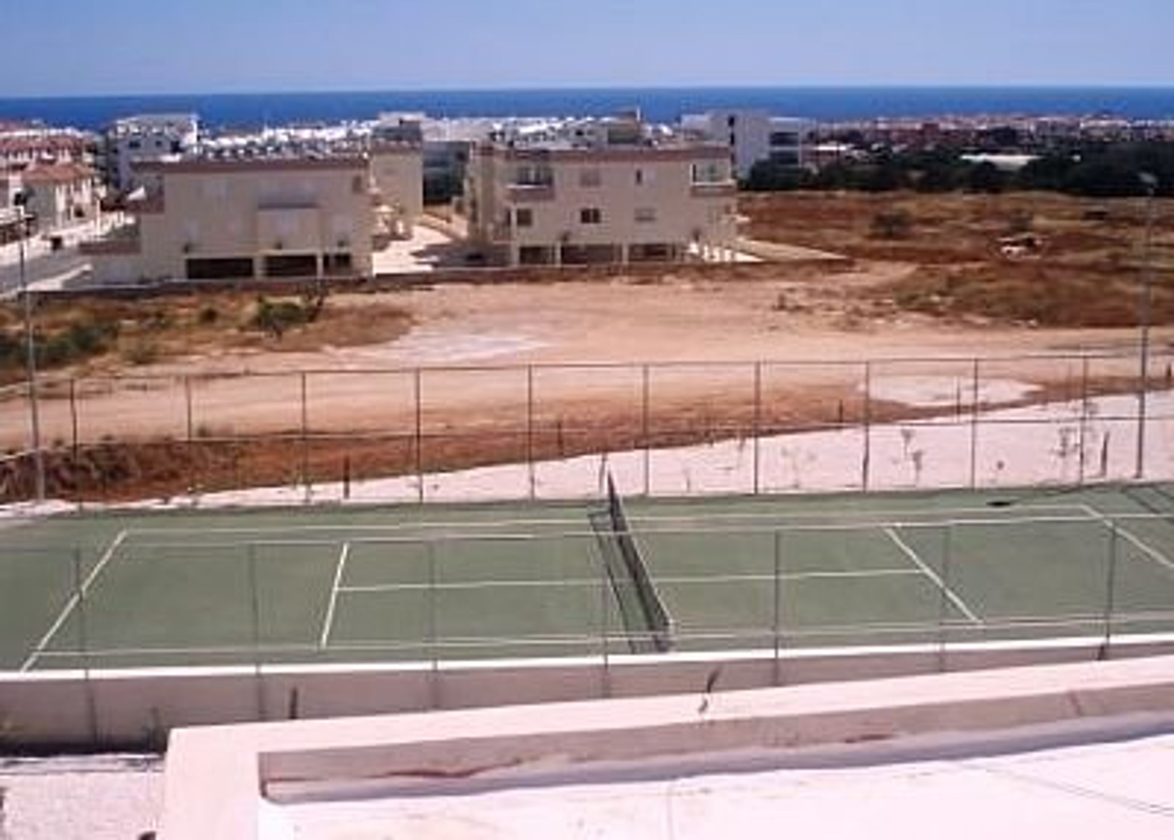 View over tennis courts to sea