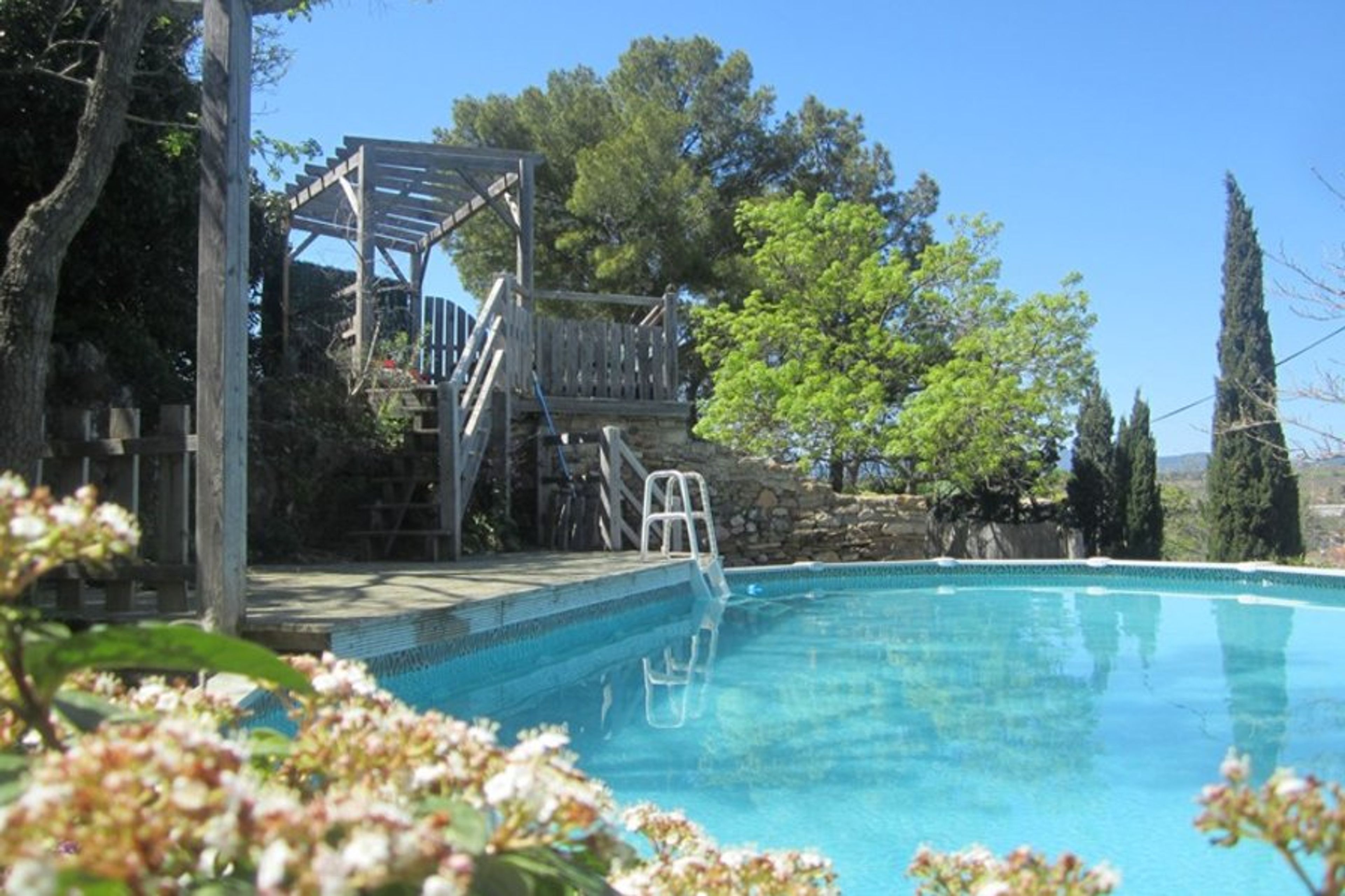 Below castle walls, above ground pool and sun deck have views to far horizon