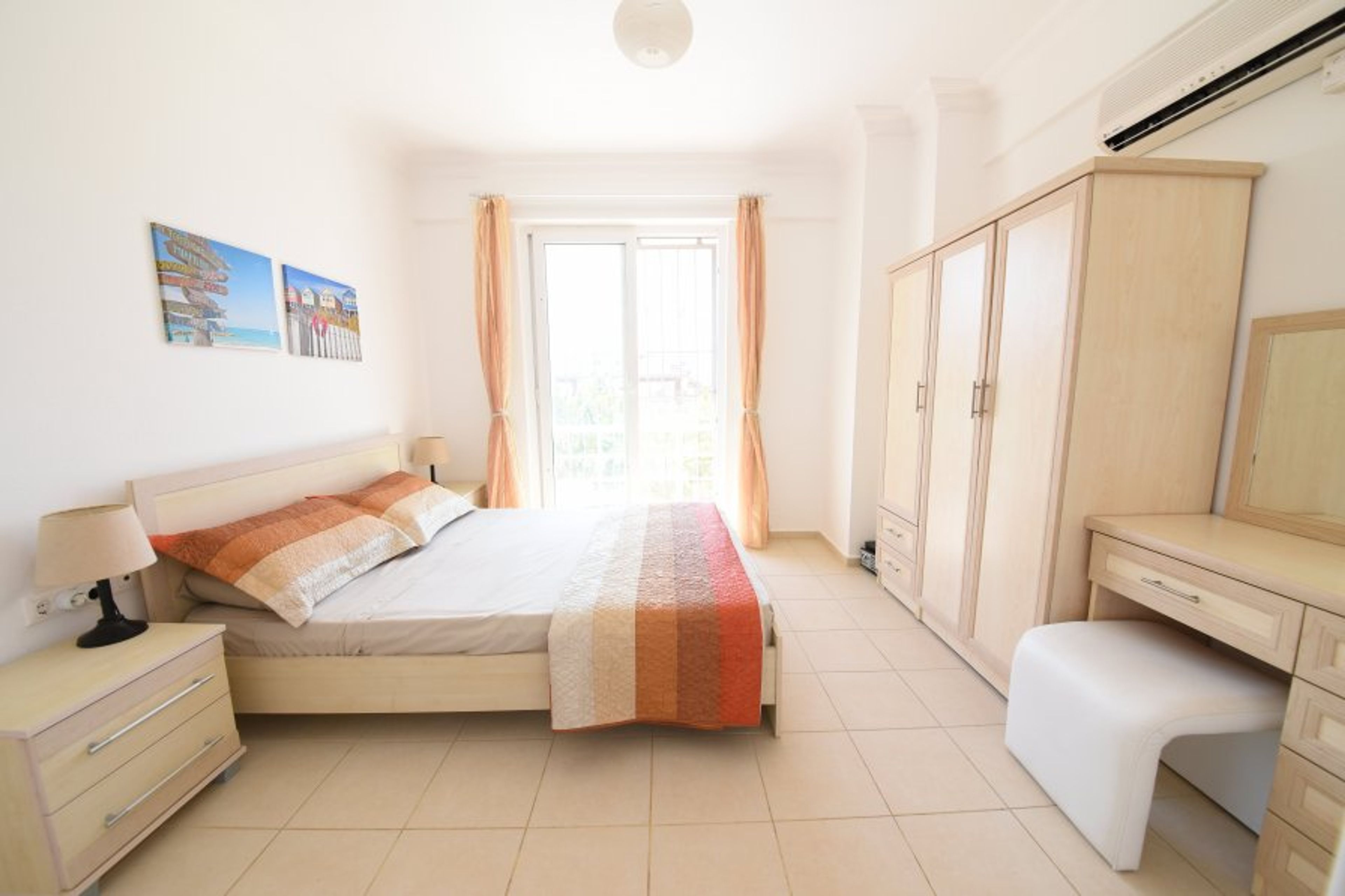Bright and spacious master bedroom with large patio doors