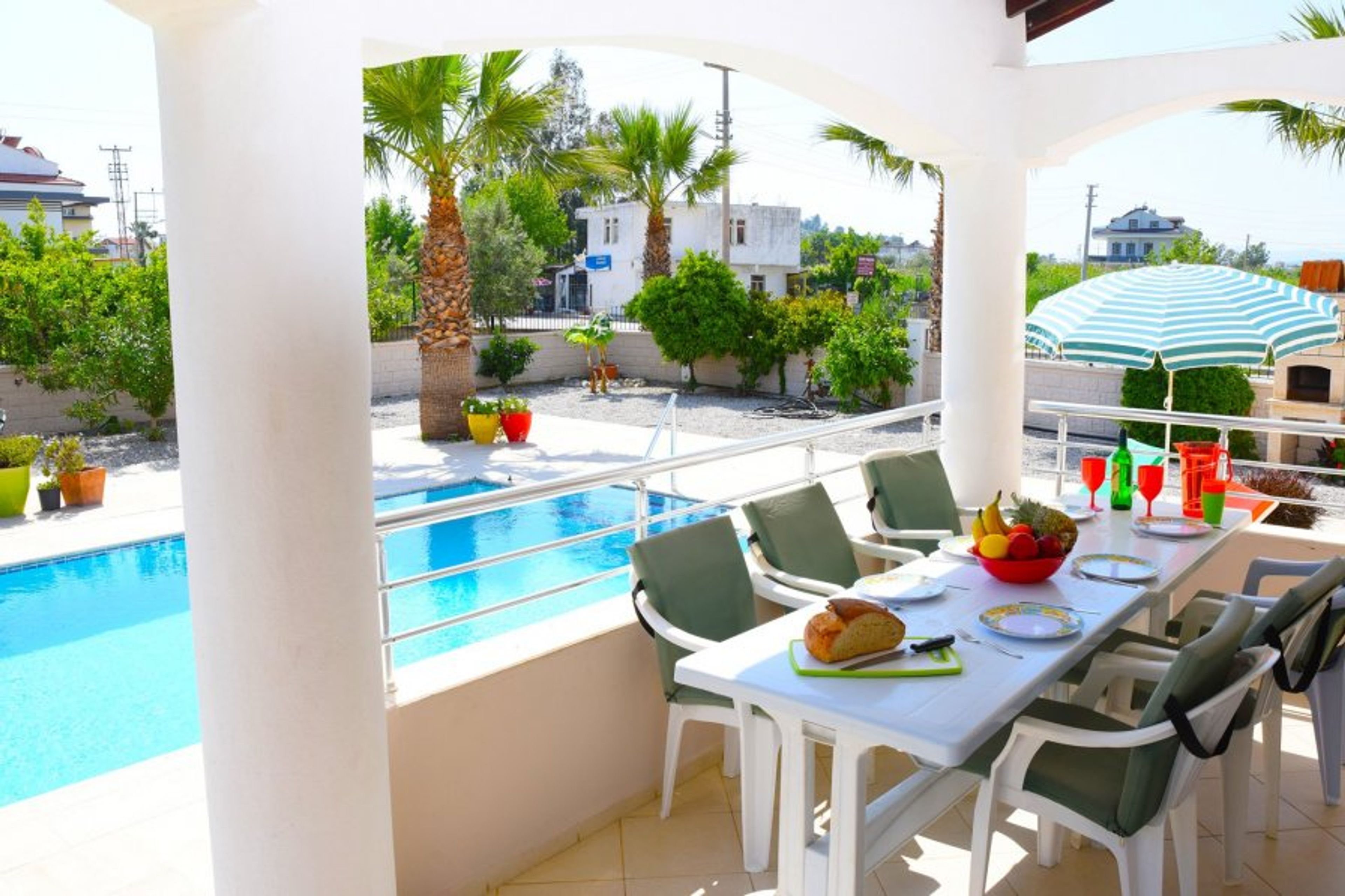 Shaded terrace dining area overlooking the private pool