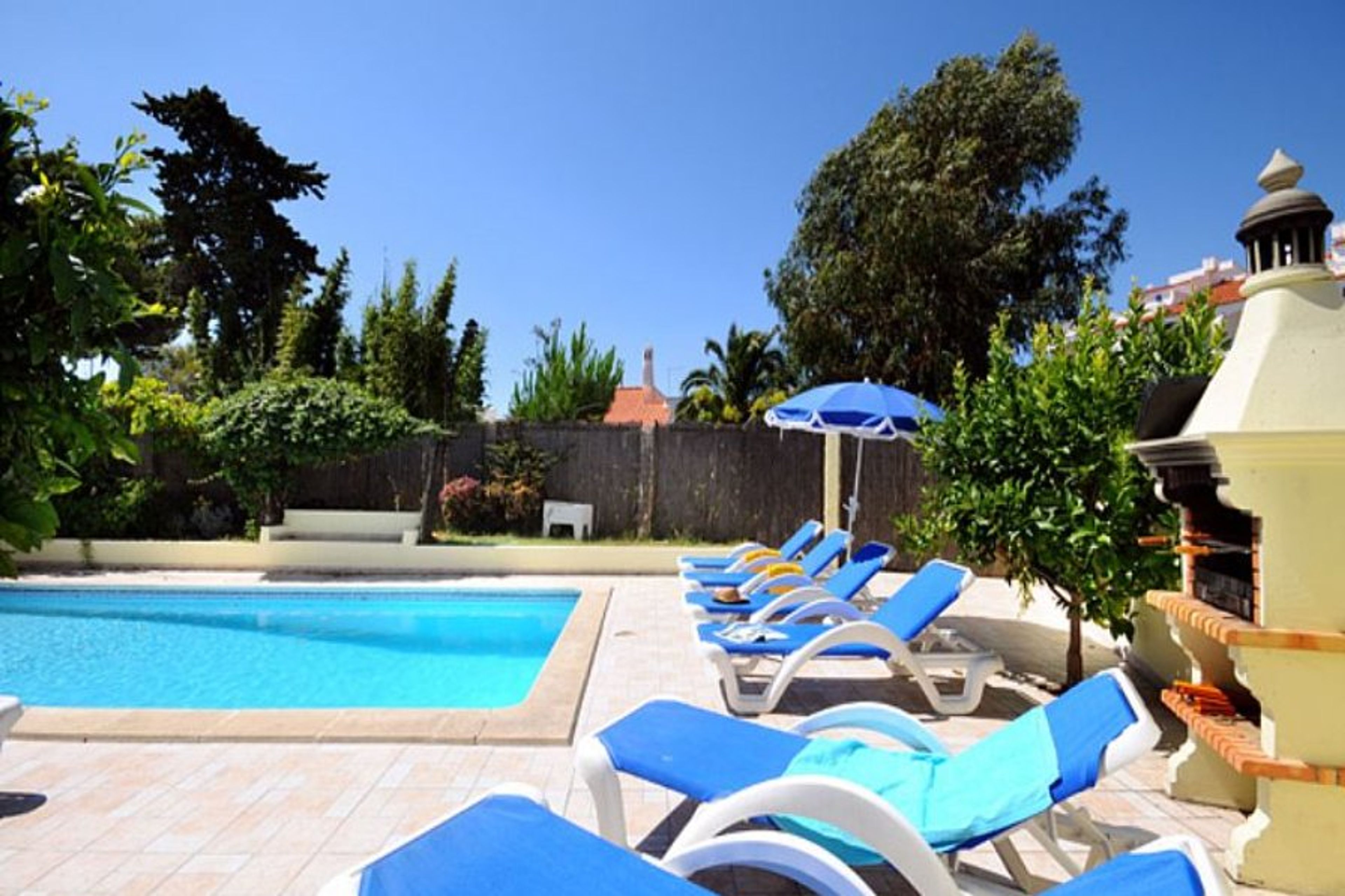 sunloungers and BBQ beside the pool