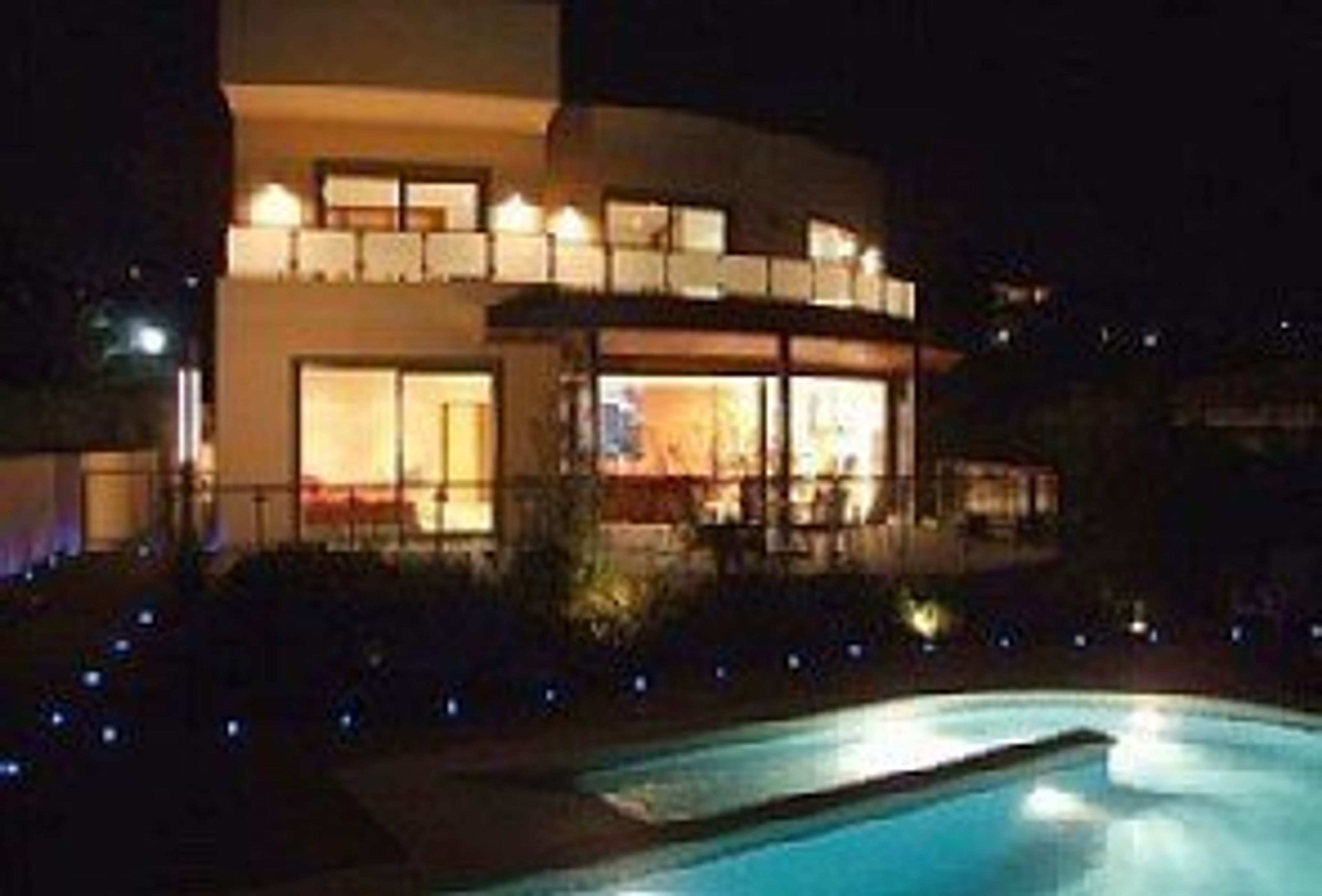 The villa and pool at night.